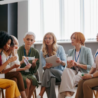 Group of confident mature women examining beauty products during specialized conference